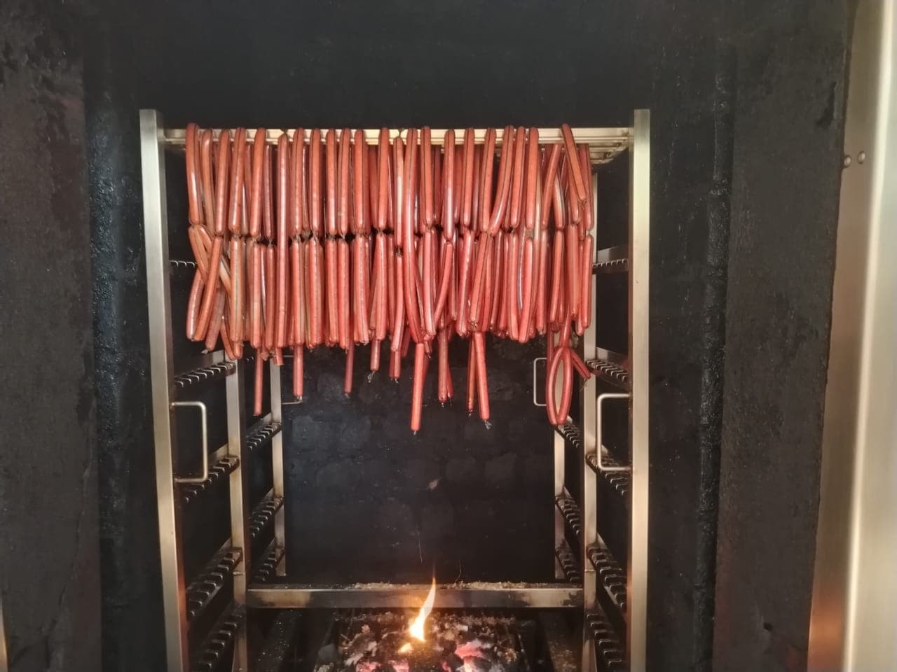 Sausages smoking over an open fire